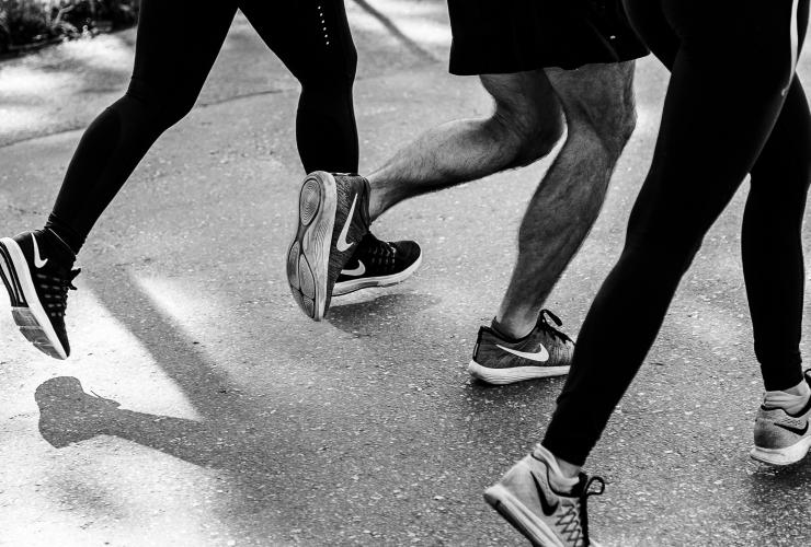 group of people running in a city