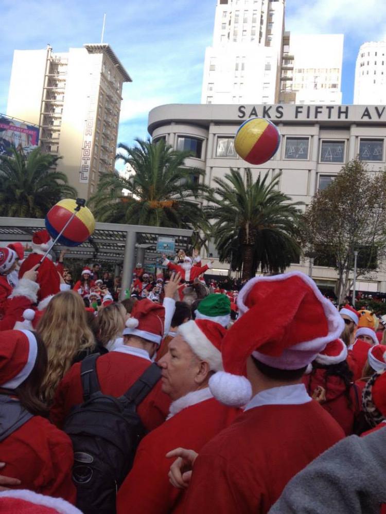 People dressed in Santa suits celebrate SantaCon 2014 in Union Square in San Francisco.